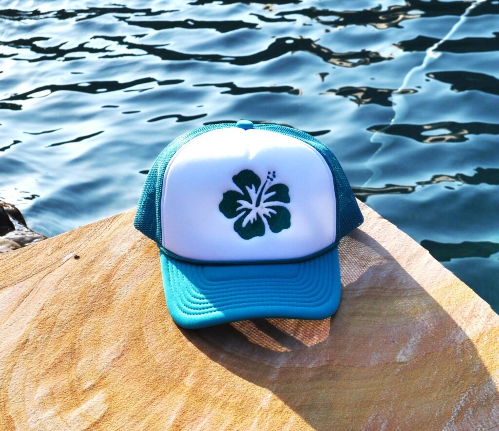 Beuatiful Embroidered Hibiscus Flower on a teal and white foam trucker hat