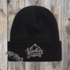 Black beanie with adventure awaits embroidered on it