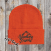 Orange beanie with adventure awaits embroidered on it