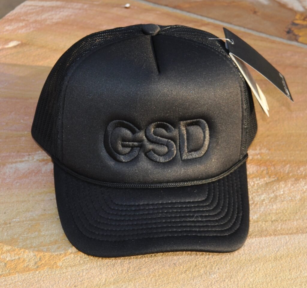 Solid black foam trucker hat with initials embroidered in same color