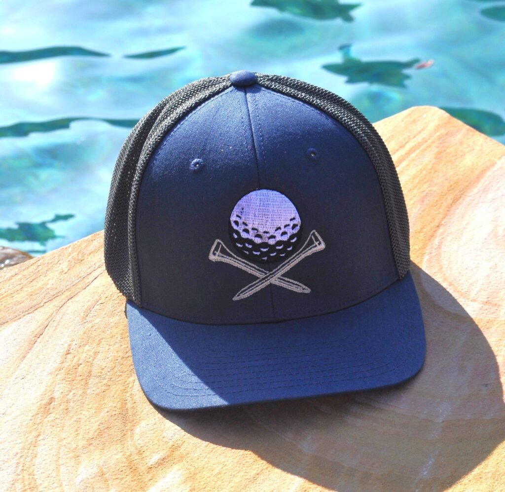 Navy and gray flexfit hat with golf ball and tees embroidered on the front