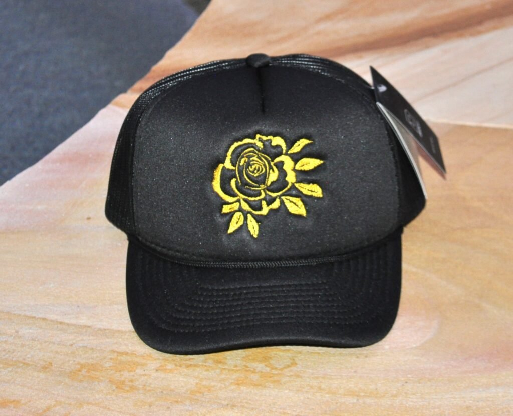 Black Foam Trucker hat with yellow rose embroidered on the front