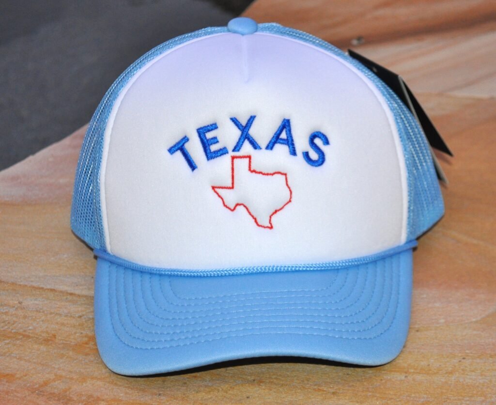 Light blue and white trucker hat with Texas embroidered on the front