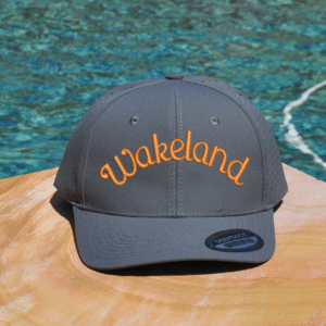 Gray athletic cap with school name embroidered on the front