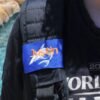 Luggage tag wrap displayed on bag strap