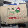 Cream sweatshirt with grinch day schedule embroidered on the front