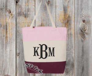 Maroon tricolor canvas bag with monogram on the front Maroon tricolor canvas bag with monogram on the front