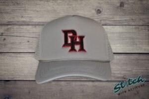 Daddy Hack Monogram embroidery detail on foam trucker Daddy Hack DH monogram embroidery detail, red and black thread on light gray hat