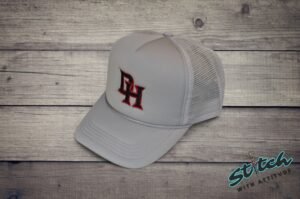 Daddy Hack Monogram on light gray foam trucker hat, side view Daddy Hack DH monogram embroidered on light gray foam trucker hat, side profile with mesh back