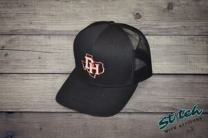 Daddy Hack open Texas design embroidered on black trucker hat, angled view