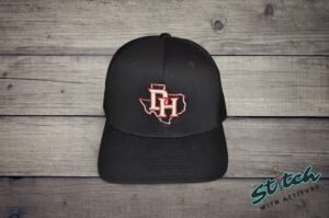 Daddy Hack open Texas design embroidered on black trucker hat, close view