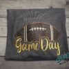 Game Day Glitter Football Embroidered Sweatshirt. You already live at the field. This is what you wear there. A glitter football applique, Game Day in stitched script, and the thre