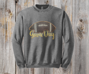 Game Day Glitter Football Embroidered Sweatshirt. You already live at the field. This is what you wear there. A glitter football applique, Game Day in stitched script, and the thre