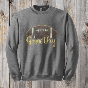 Game Day Glitter Football Embroidered Sweatshirt. You already live at the field. This is what you wear there. A glitter football applique, Game Day in stitched script, and the thre