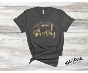 Game Day Glitter Football Embroidered Sweatshirt. You already live at the field. This is what you wear there. A glitter football applique, Game Day in stitched script, and the thre
