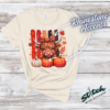 Highland Cow Fall Pumpkin Rhinestone Tee. A shaggy little cow in a plaid bow, three pumpkins, and real rhinestones set by hand. Fall, wearing it loudly.