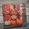 Highland Cow Fall Pumpkin Rhinestone Tee. A shaggy little cow in a plaid bow, three pumpkins, and real rhinestones set by hand. Fall, wearing it loudly.