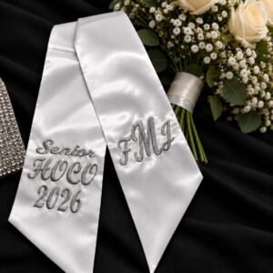 Custom Embroidered HOCO Bouquet Ribbon - Homecoming-Bouquet-Sash-1.jpg Homecoming bouquet sash in white satin, embroidered HOCO 2026 on one side and a monogram on the other.