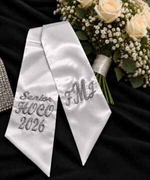 Custom Embroidered HOCO Bouquet Ribbon - Homecoming-Bouquet-Sash-1.jpg Homecoming bouquet sash in white satin, embroidered HOCO 2026 on one side and a monogram on the other.