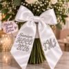 Custom Embroidered HOCO Bouquet Ribbon - Homecoming-Bouquet-Sash-2.jpg Homecoming bouquet sash in white satin, embroidered HOCO 2026 on one side and a monogram on the other.