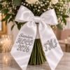 Custom Embroidered HOCO Bouquet Ribbon - Homecoming-Bouquet-Sash-6.jpg Homecoming bouquet sash in white satin, embroidered HOCO 2026 on one side and a monogram on the other.