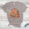 Stacked Pumpkins Fall Tee with Rhinestone Accents - Stacked-Pumpkins-Rhinestone-Tee-1.jpg Stacked Pumpkins Fall Tee with Rhinestone Accents. Three painted pumpkins under a gingham bow, with mushrooms, sunflowers and stars, and real rhinestones set by hand across the des