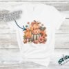 Stacked Pumpkins Fall Tee with Rhinestone Accents - Stacked-Pumpkins-Rhinestone-Tee-2.jpg Stacked Pumpkins Fall Tee with Rhinestone Accents. Three painted pumpkins under a gingham bow, with mushrooms, sunflowers and stars, and real rhinestones set by hand across the des