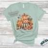 Stacked Pumpkins Fall Tee with Rhinestone Accents - Stacked-Pumpkins-Rhinestone-Tee-5.jpg Stacked Pumpkins Fall Tee with Rhinestone Accents. Three painted pumpkins under a gingham bow, with mushrooms, sunflowers and stars, and real rhinestones set by hand across the des