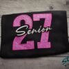 Senior 2027 Glitter Sweatshirt photo Senior 2027 glitter sweatshirt, folded, pink glitter 27 with Senior embroidered in white script