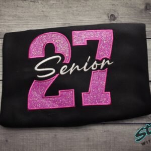 Senior 2027 glitter sweatshirt, folded, pink glitter 27 with Senior embroidered in white script